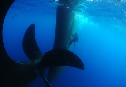 Diver Inspecting Cleaning Ship Rudder